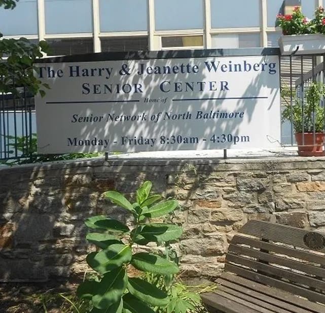 A bench in front of the harry weinberg senior center.