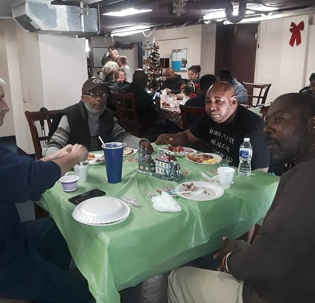 A group of people sitting at a table eating.