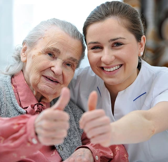 A woman and an old lady giving thumbs up