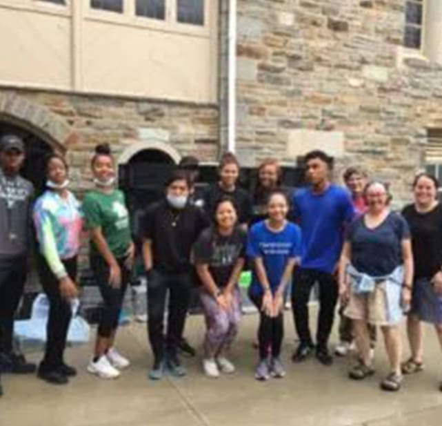 A group of people standing in front of a building.