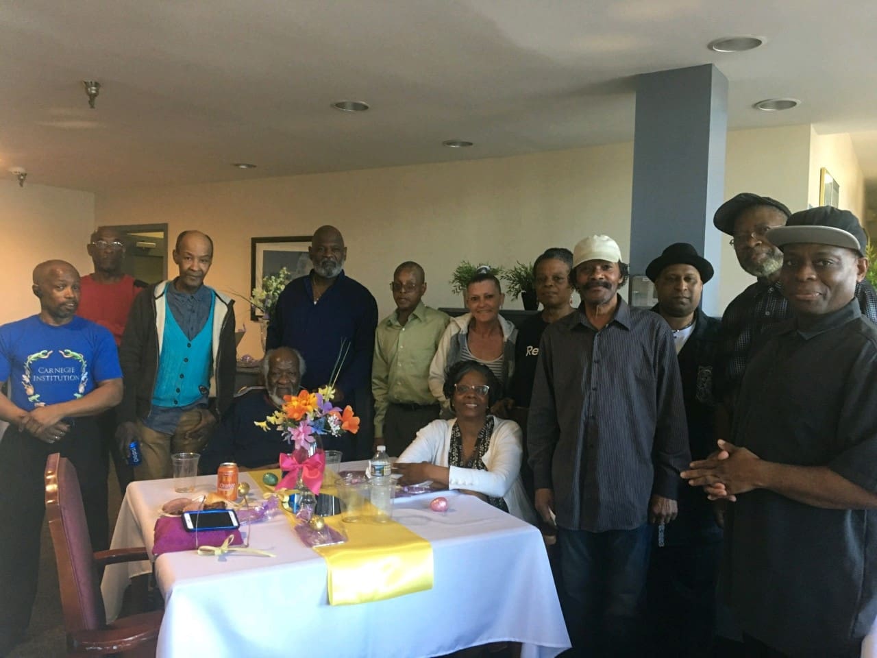 A group of people standing around a table.