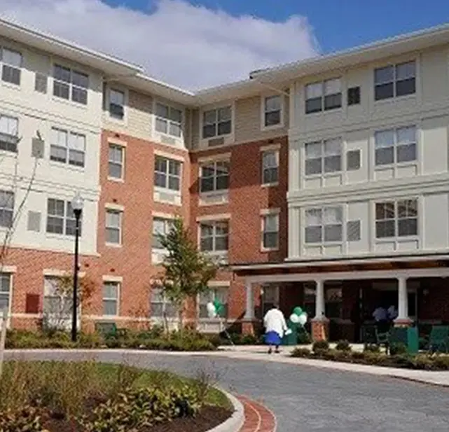 A large building with many windows and trees